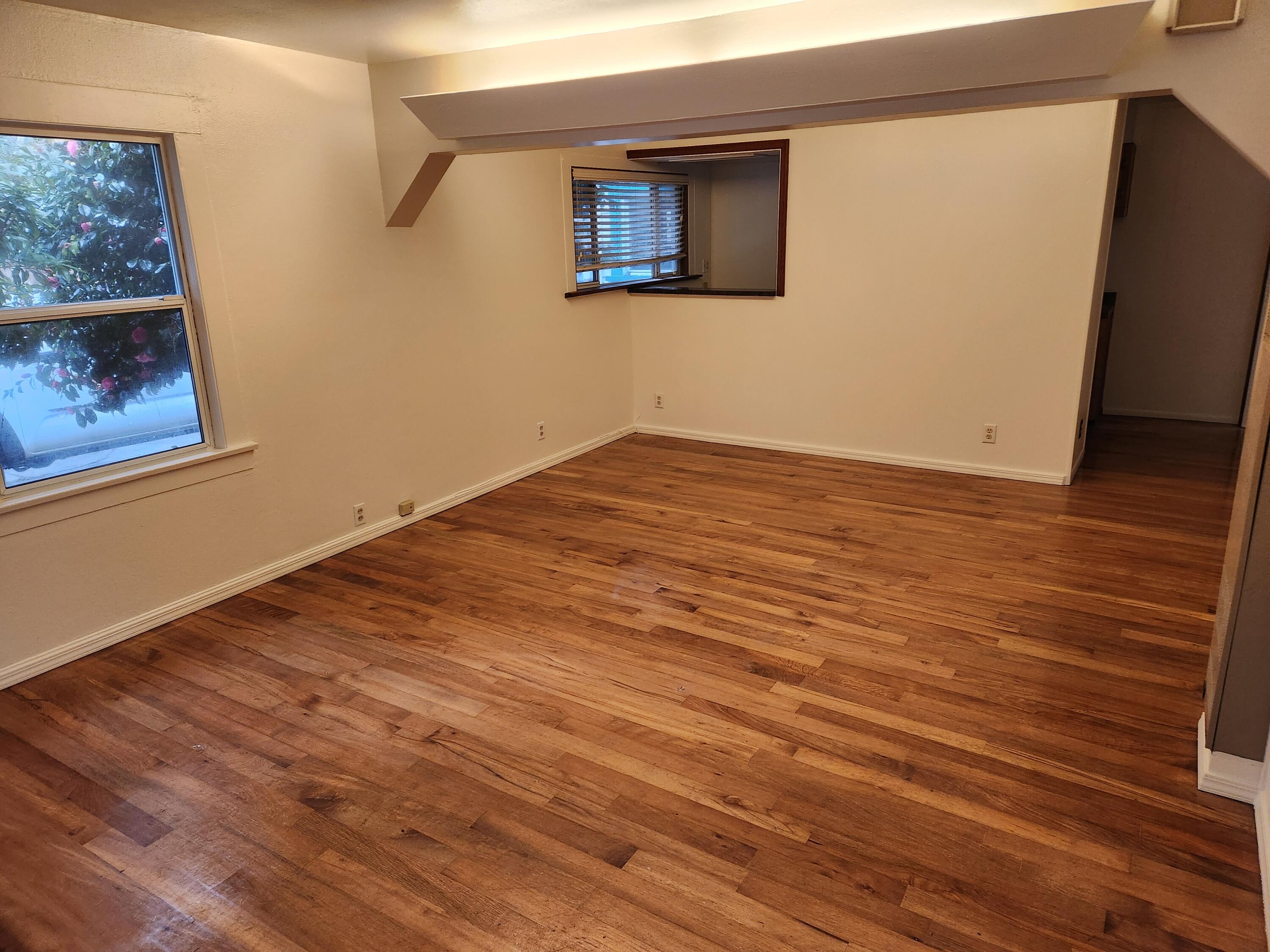 2163 Fern Street Cutten, CA 95503 - Photo 12 of 23 a view of an empty room with wooden floor and a window