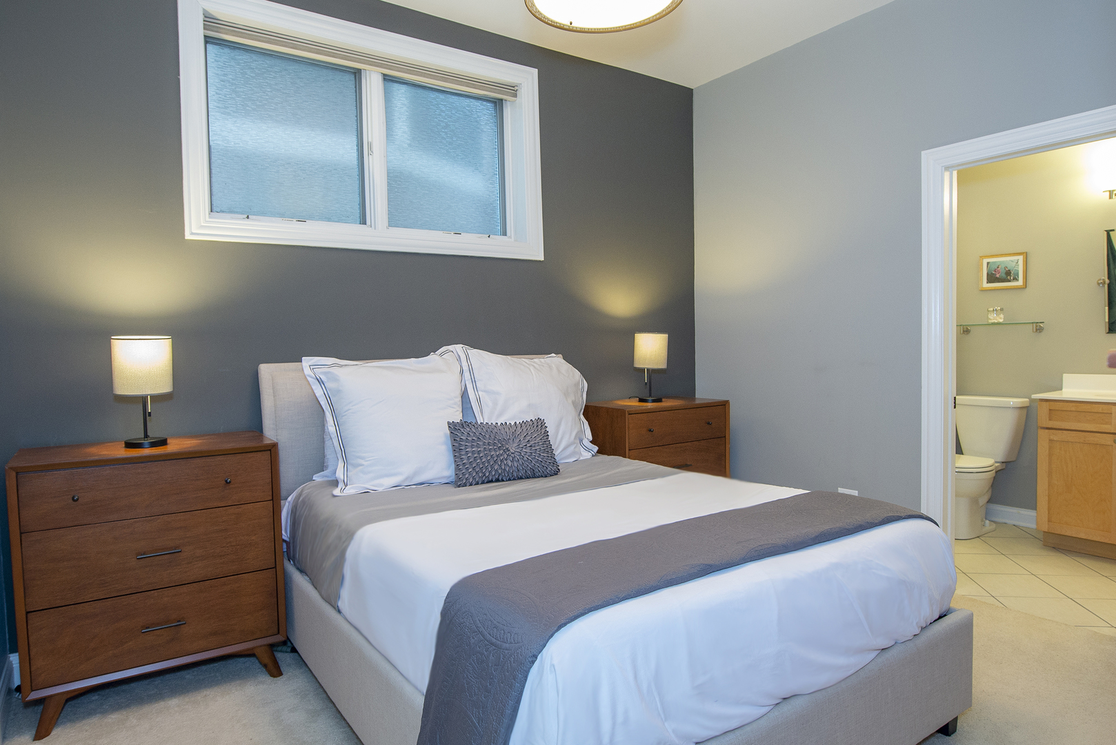 4606 North Malden Street, Unit GS Chicago, IL 60640 - Photo 7 of 16 a bedroom with a bed and a night stand