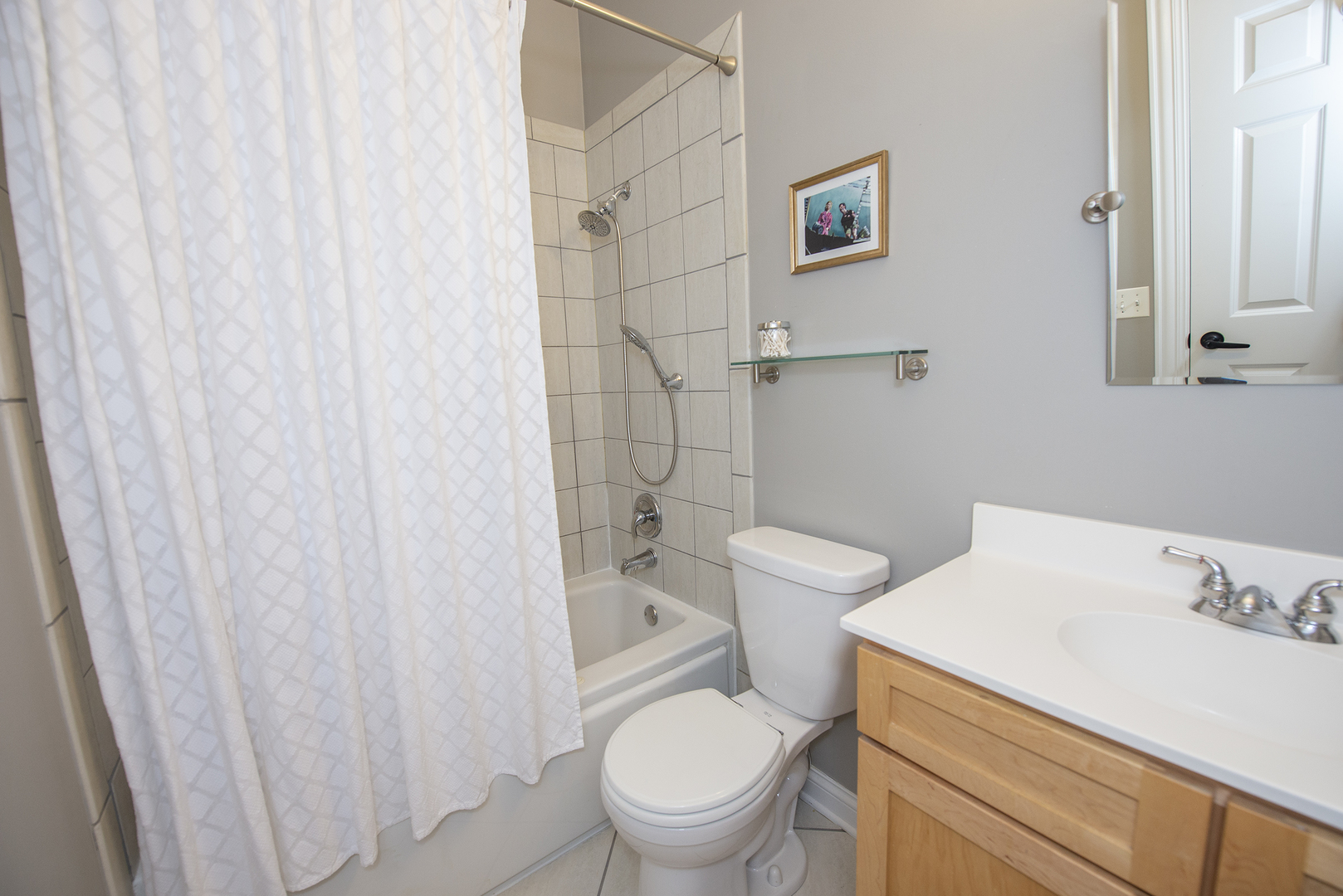 4606 North Malden Street, Unit GS Chicago, IL 60640 - Photo 9 of 16 a white toilet sitting next to a bathroom sink