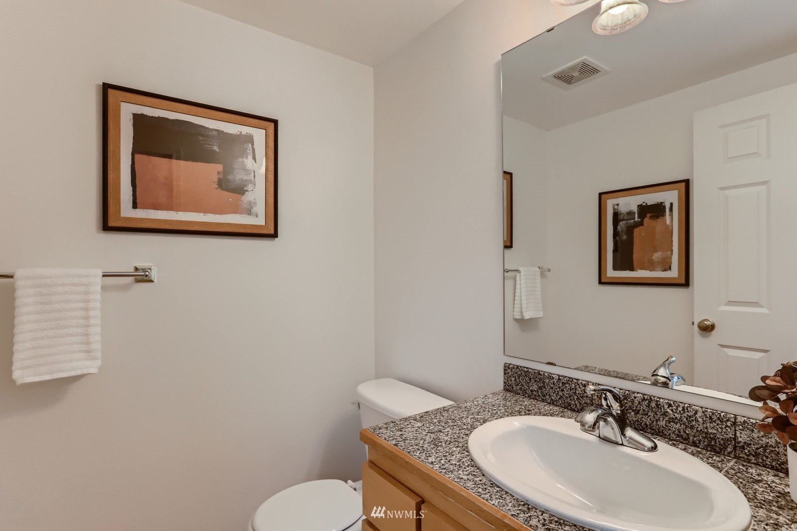 1512 Northwest 57th Street, Unit D Seattle, WA 98107 - Photo 11 of 29 a bathroom with a granite countertop sink mirror vanity and toilet