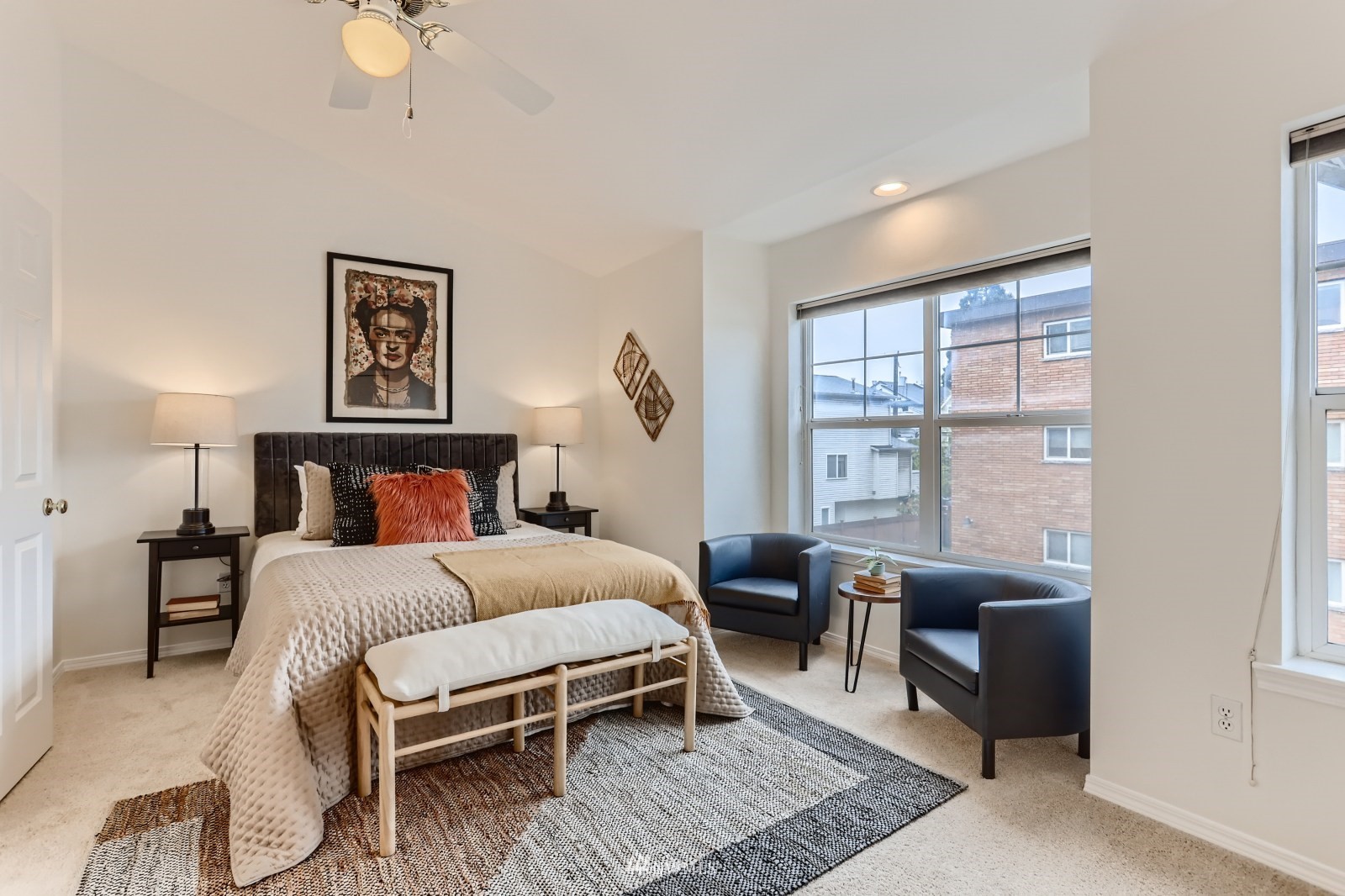 1512 Northwest 57th Street, Unit D Seattle, WA 98107 - Photo 12 of 29 a bedroom with a large bed a couch and a window