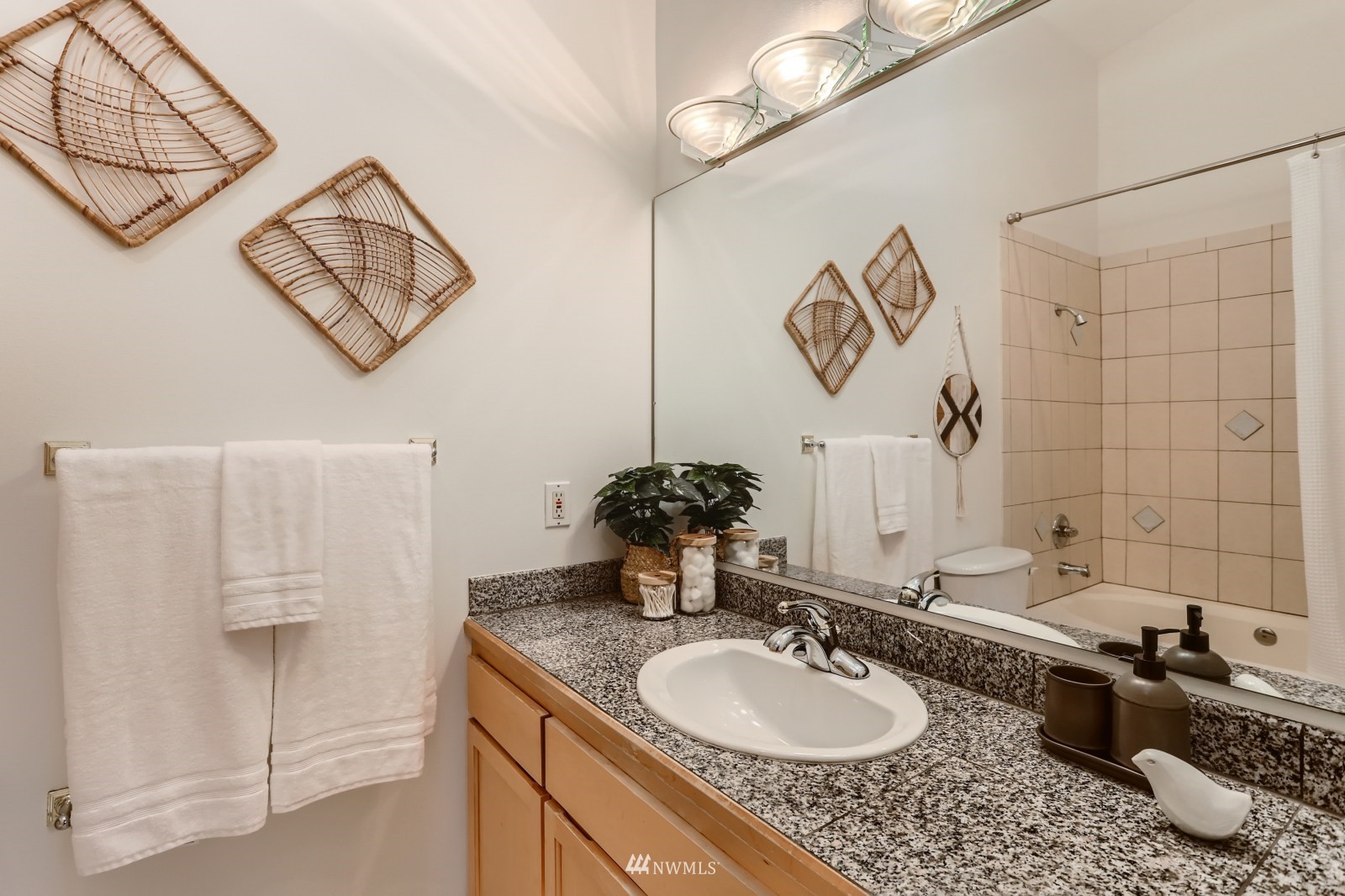 1512 Northwest 57th Street, Unit D Seattle, WA 98107 - Photo 15 of 29 a bathroom with a granite countertop sink and a mirror