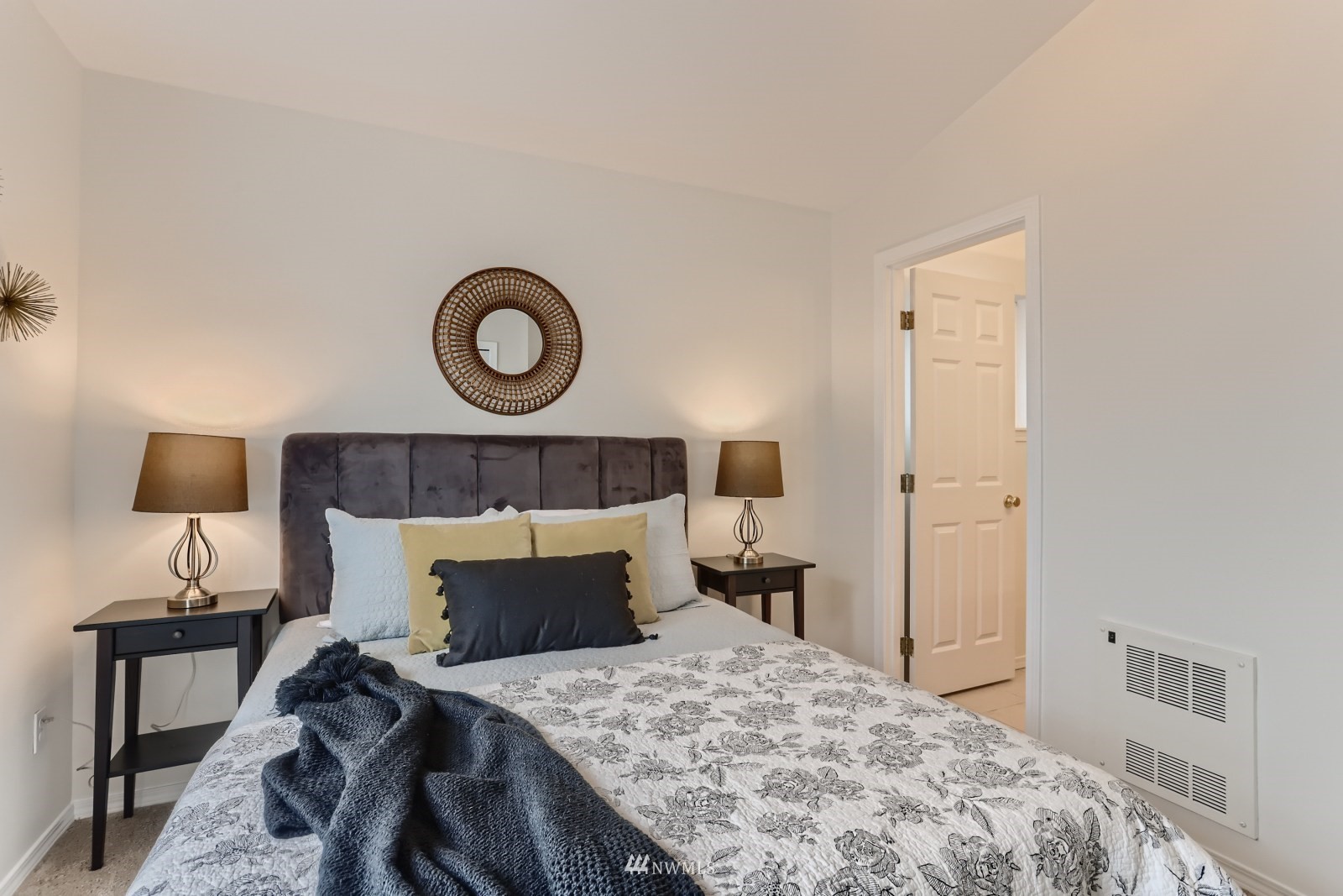1512 Northwest 57th Street, Unit D Seattle, WA 98107 - Photo 17 of 29 a bedroom with a bed and a lamp on table