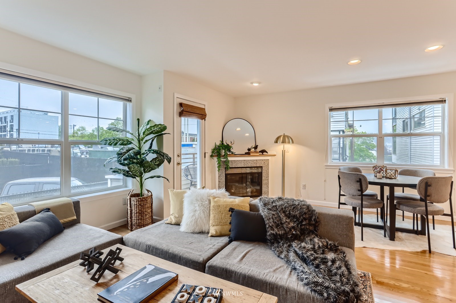 1512 Northwest 57th Street, Unit D Seattle, WA 98107 - Photo 2 of 29 a living room with furniture a fireplace and a table