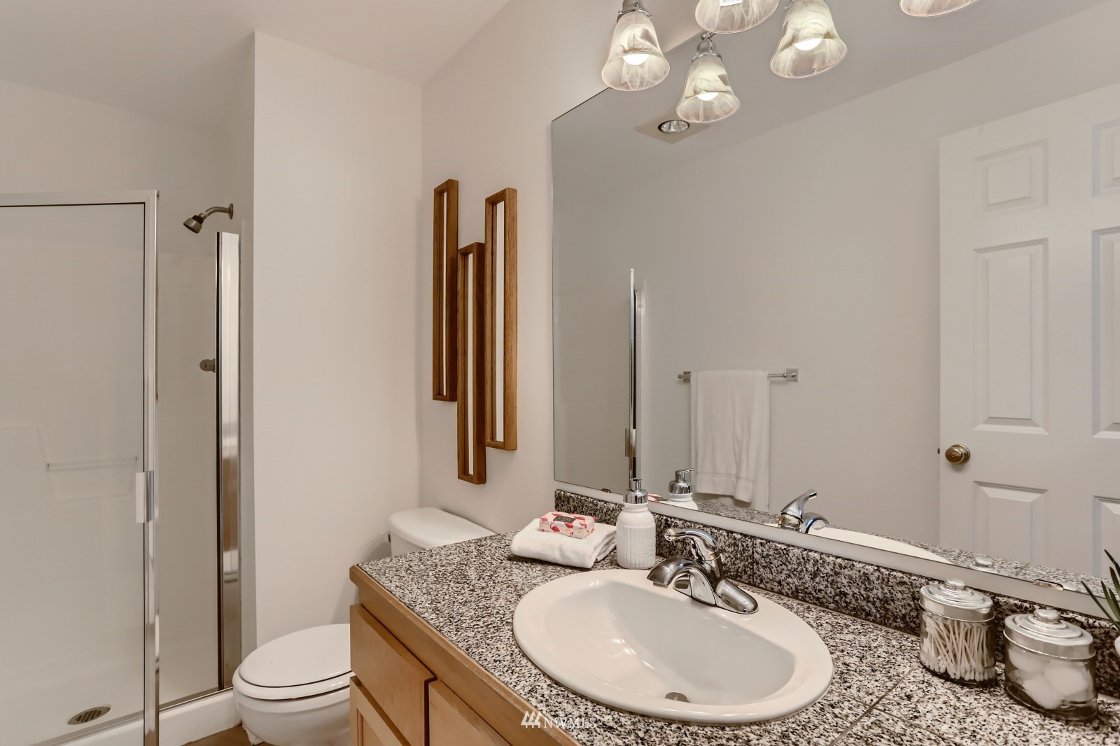1512 Northwest 57th Street, Unit D Seattle, WA 98107 - Photo 21 of 29 a bathroom with a granite countertop sink a toilet and a mirror