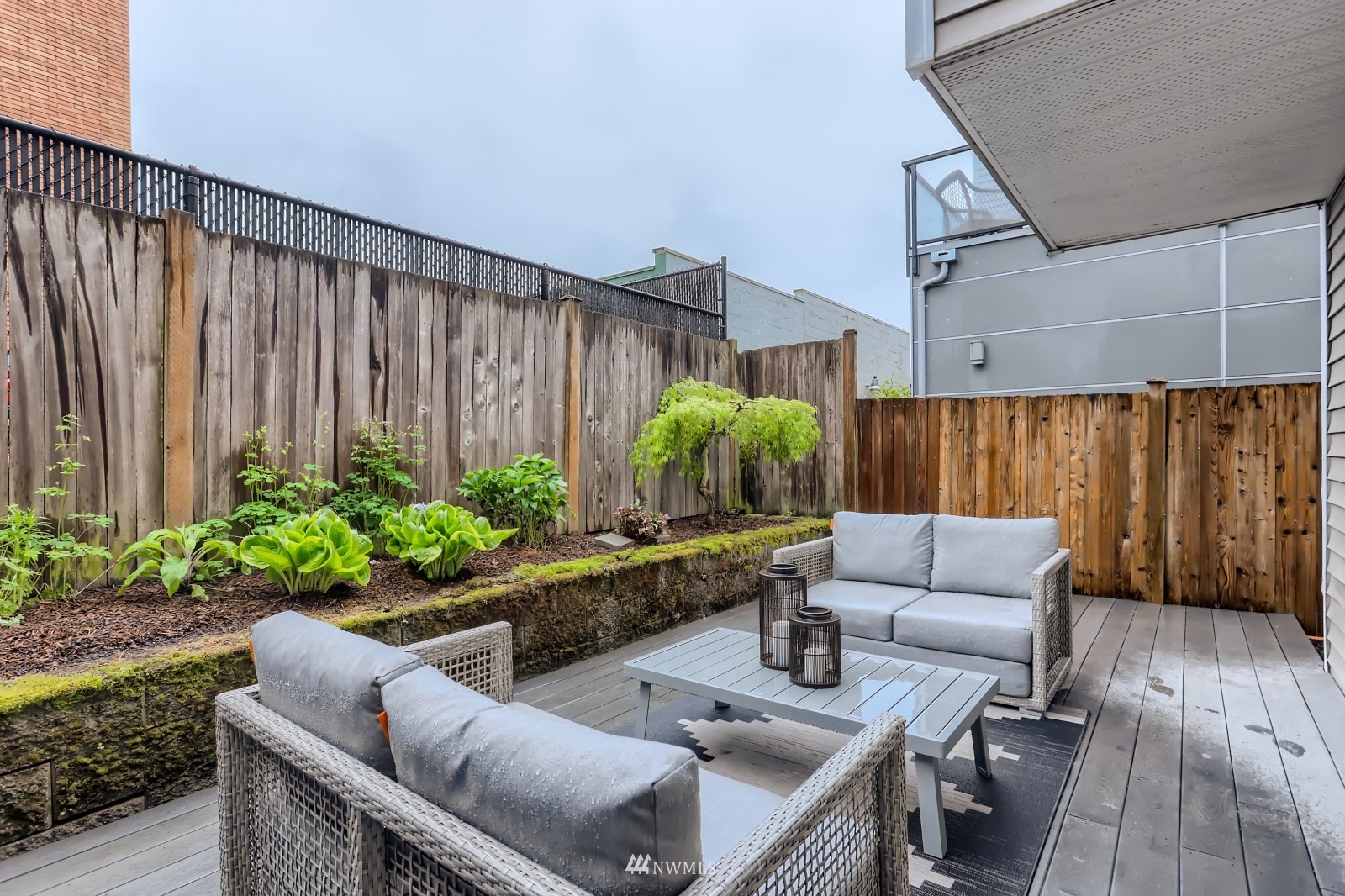 1512 Northwest 57th Street, Unit D Seattle, WA 98107 - Photo 24 of 29 a living room with patio furniture and potted plants