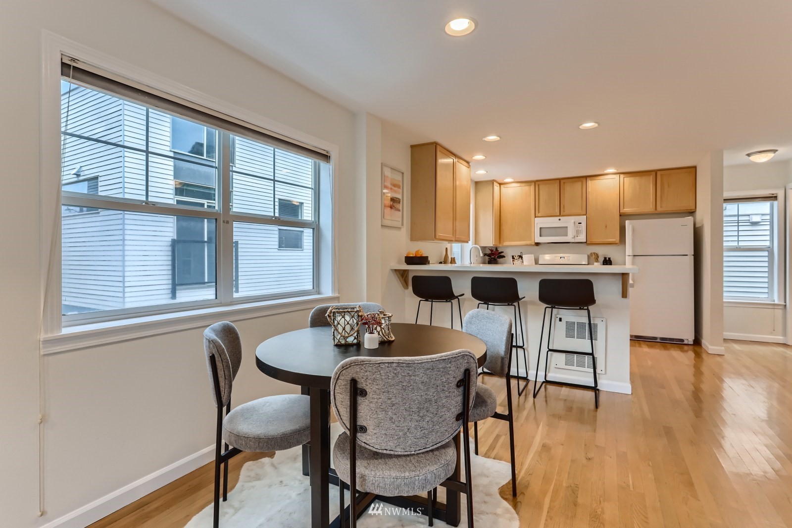 1512 Northwest 57th Street, Unit D Seattle, WA 98107 - Photo 7 of 29 a dining room with furniture and wooden floor