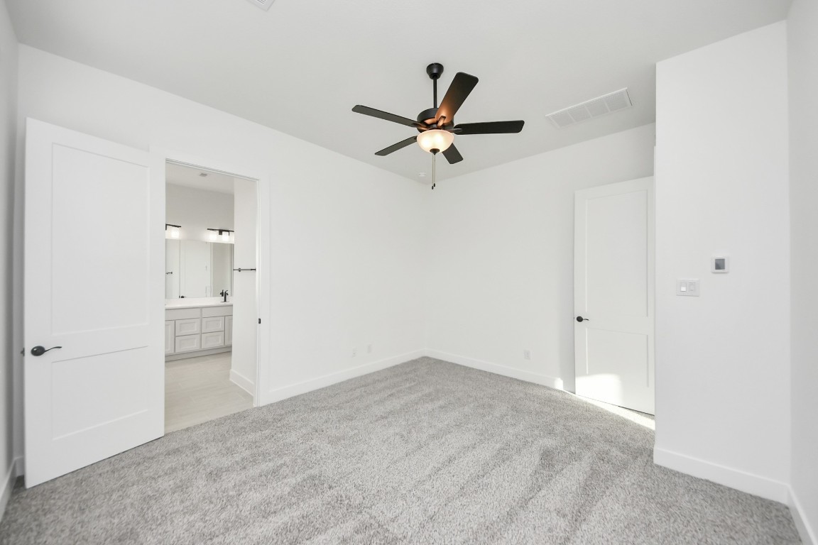 9519 Chateau Hill Manvel, TX 77578 - Photo 15 of 35 a view of a livingroom with a ceiling fan & cabinetry
