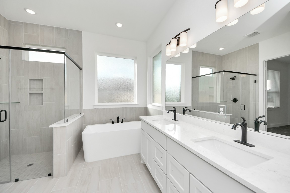 9519 Chateau Hill Manvel, TX 77578 - Photo 16 of 35 a bathroom with a double vanity sink mirror and shower