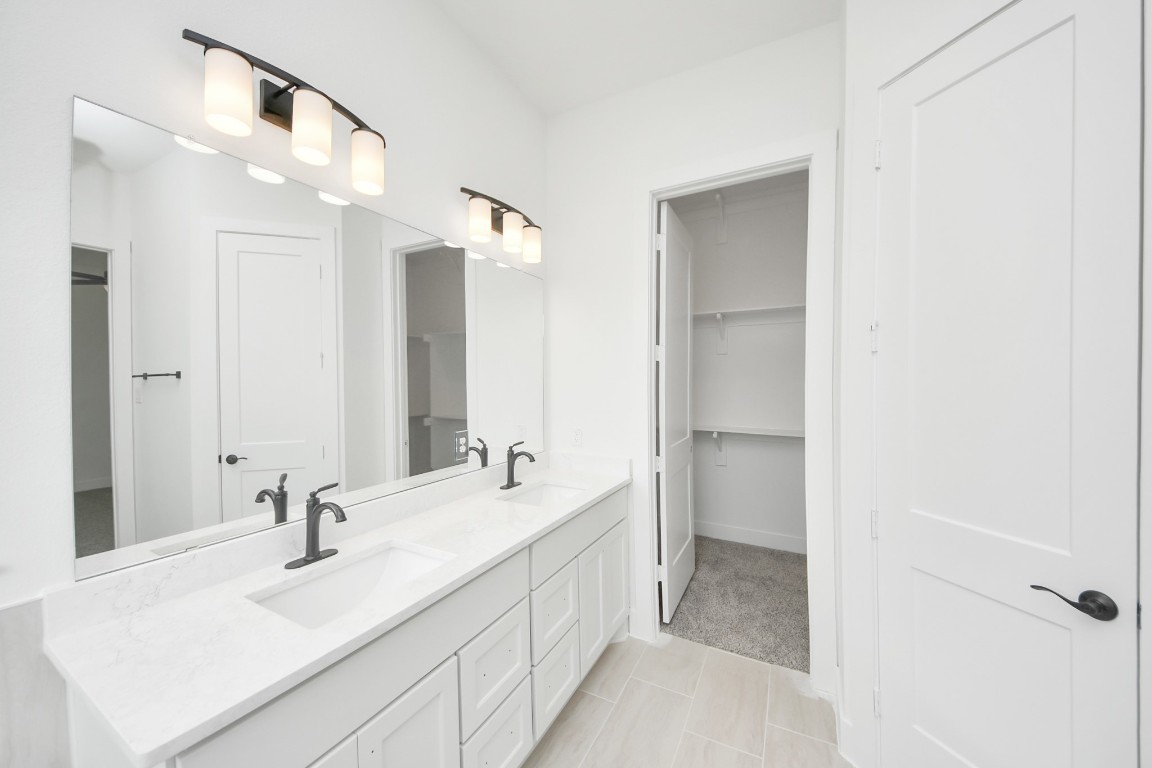 9519 Chateau Hill Manvel, TX 77578 - Photo 17 of 35 a bathroom with a double vanity sink mirror and double