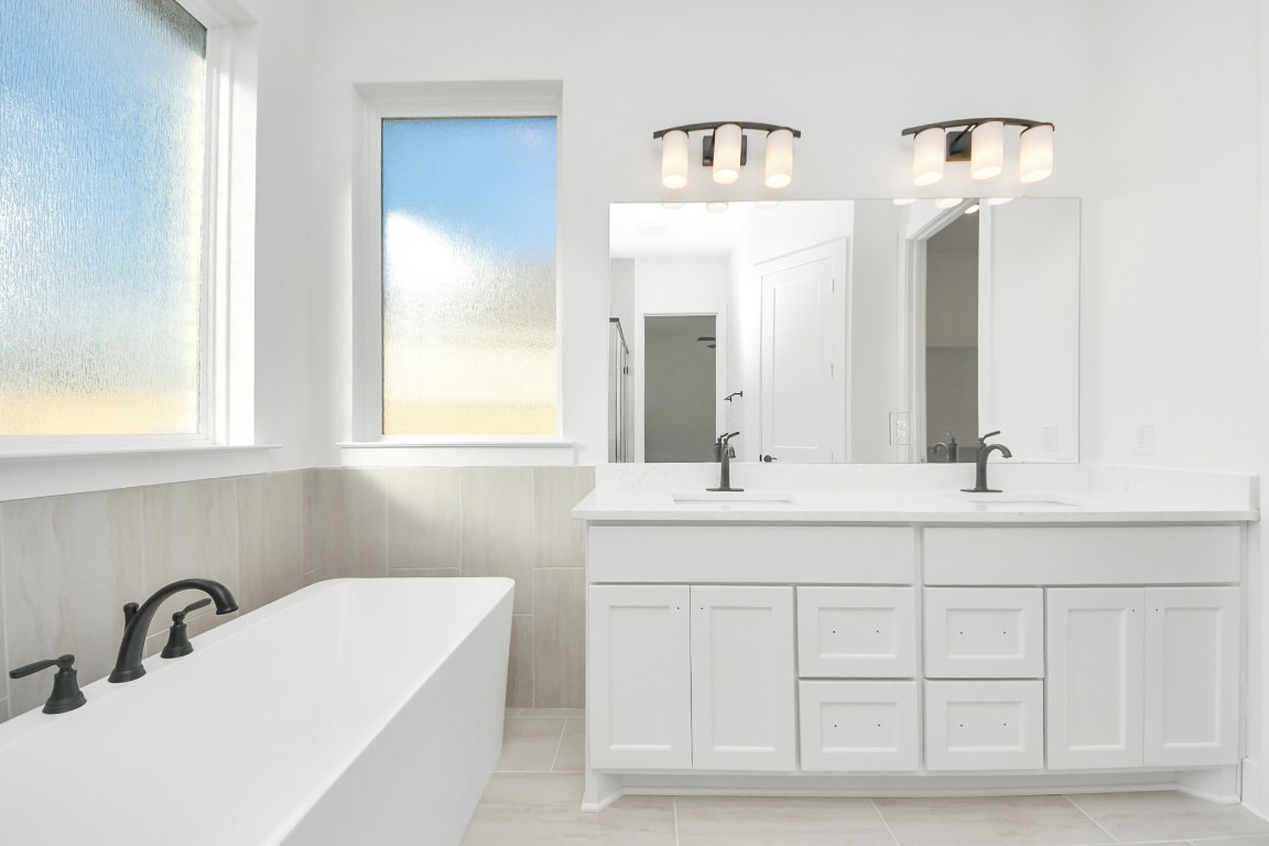 9519 Chateau Hill Manvel, TX 77578 - Photo 18 of 35 a bathroom with a sink and a mirror