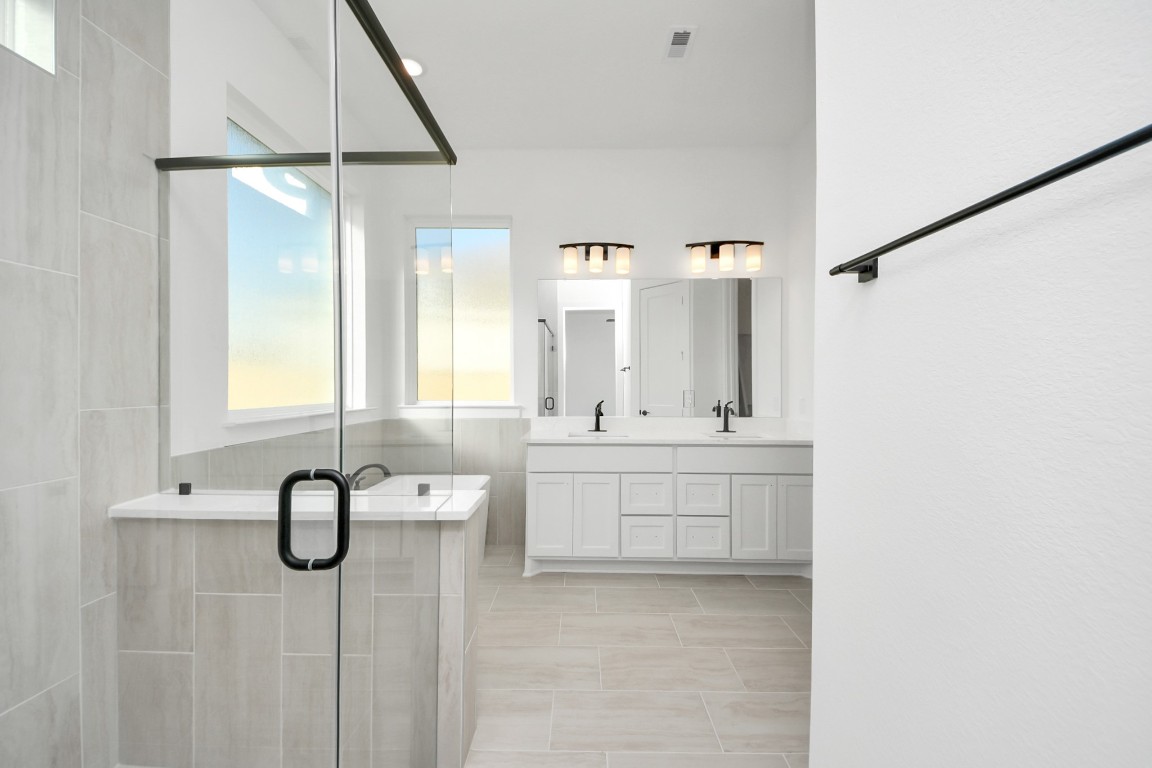 9519 Chateau Hill Manvel, TX 77578 - Photo 19 of 35 a bathroom with a double vanity sink and mirror