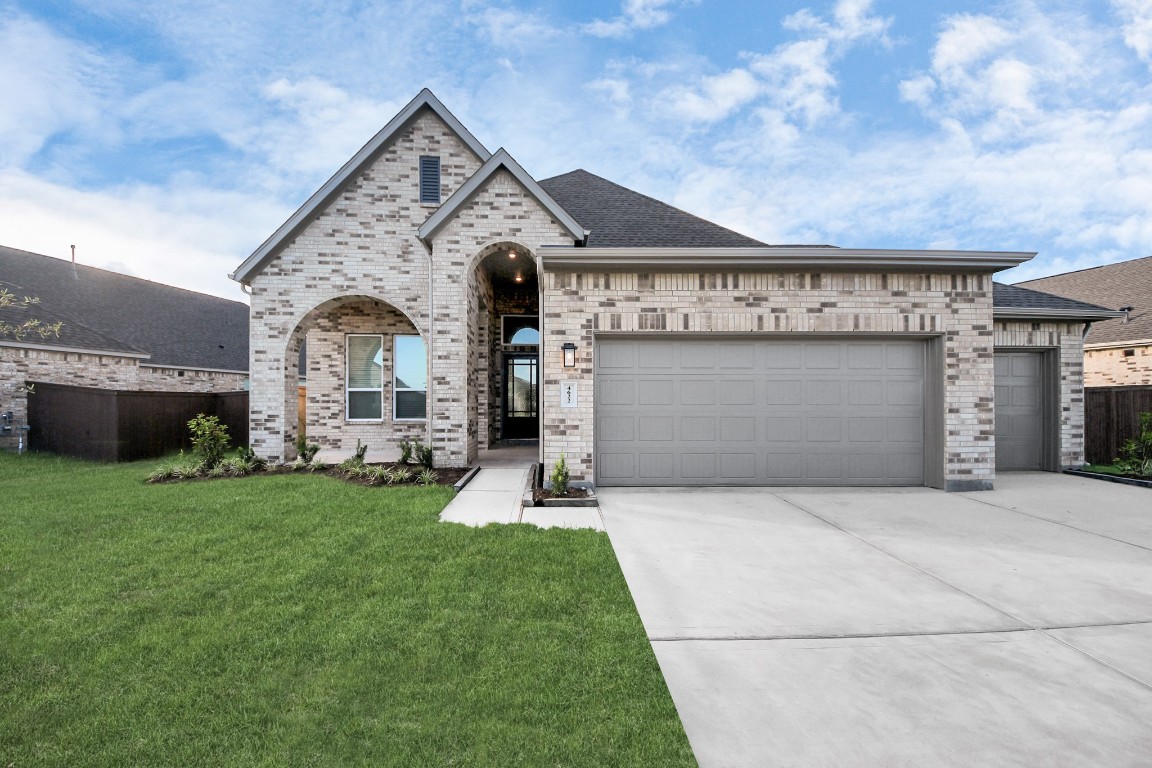 9519 Chateau Hill Manvel, TX 77578 - Photo 2 of 35 a front view of a house with a yard