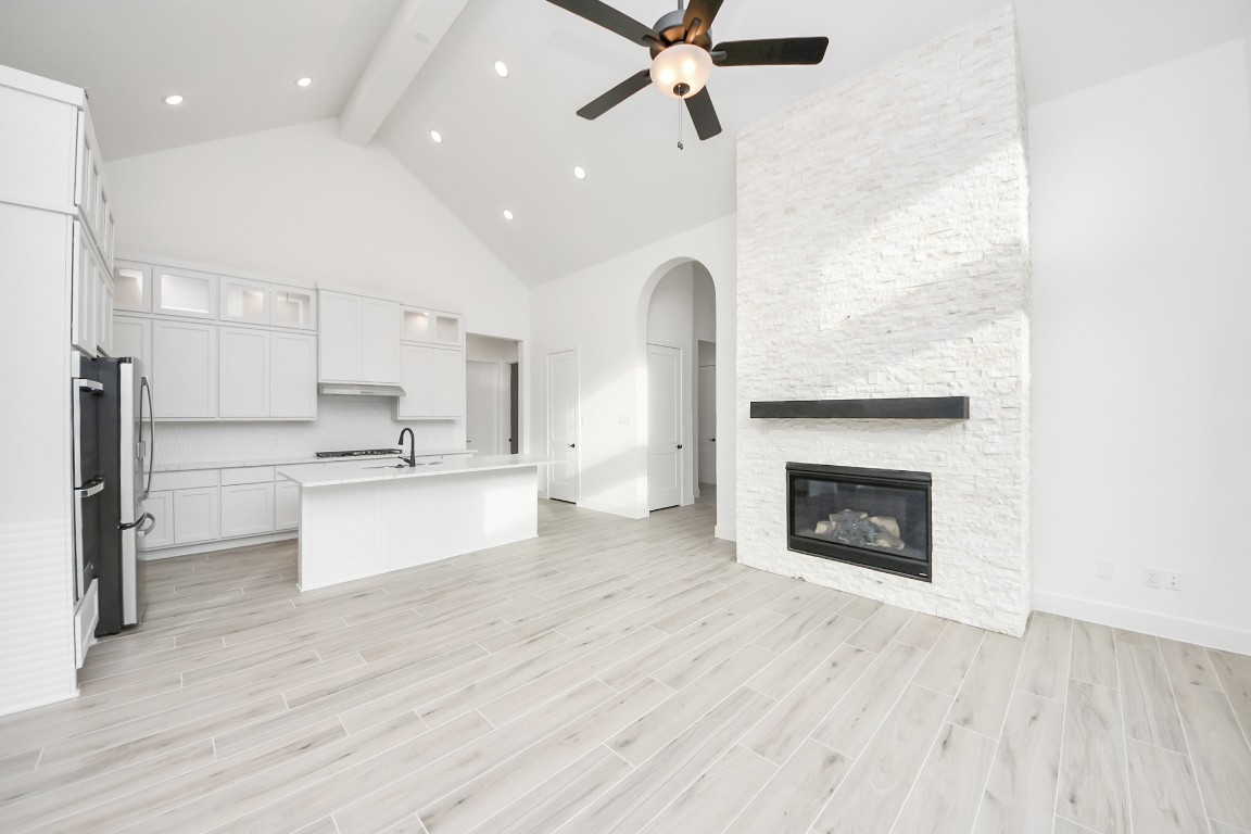 9519 Chateau Hill Manvel, TX 77578 - Photo 3 of 35 a large kitchen with cabinets a sink and dishwasher a stove with wooden floors