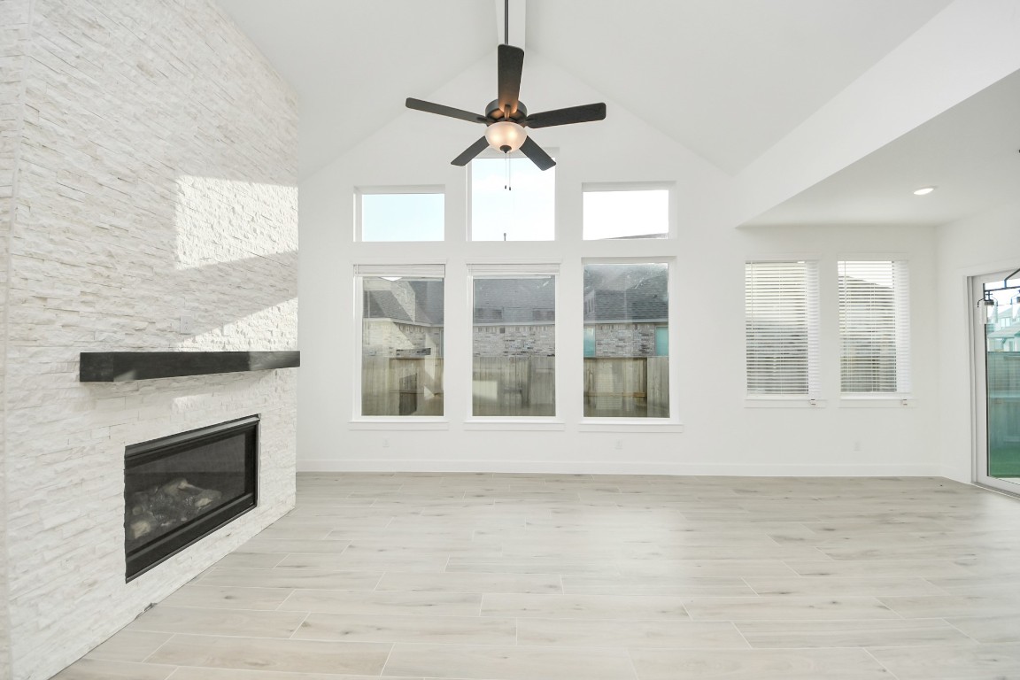 9519 Chateau Hill Manvel, TX 77578 - Photo 7 of 35 a view of an empty room with a fireplace and a window