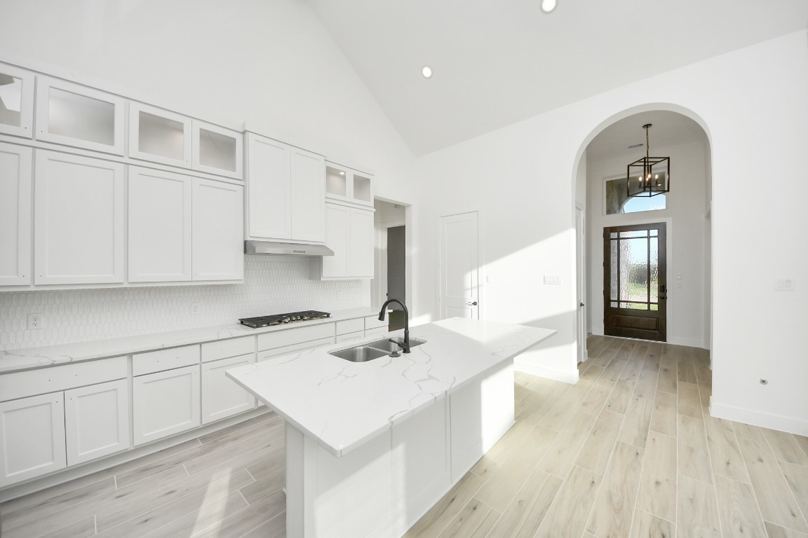 9519 Chateau Hill Manvel, TX 77578 - Photo 9 of 35 a kitchen with white cabinets and sink