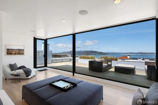 a living room with furniture and a floor to ceiling window