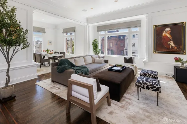 a living room with furniture and a chandelier