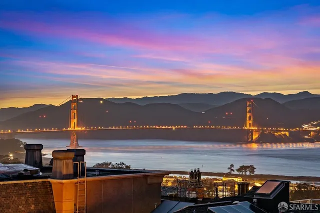a view of a bedroom with furniture and window