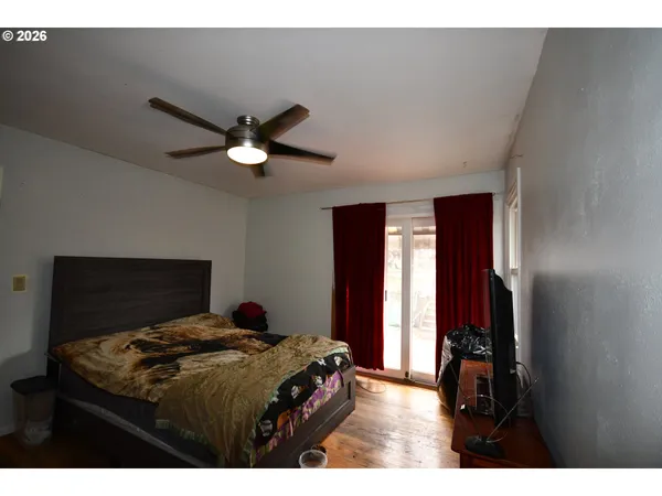 a bedroom with a bed and a ceiling fan