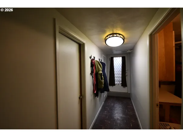 a view of a hallway with wooden shelves