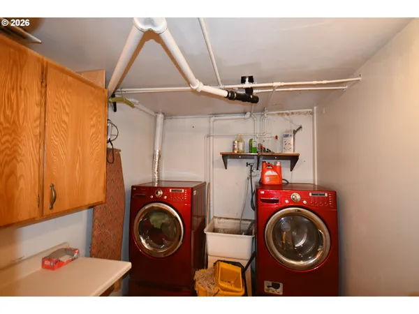 a view of a chair and table in backyard of the house