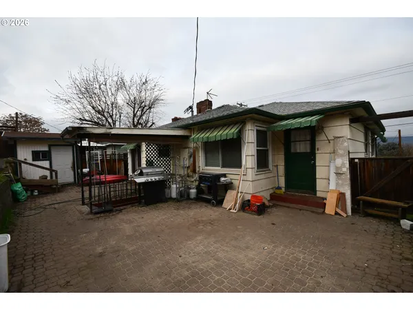 a view of a house with a backyard and chairs