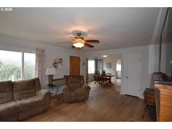 a living room with furniture a chandelier and a large window