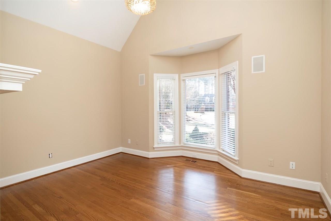 5220 Deergrass Court Raleigh, NC 27613 - Photo 15 of 25 wooden floor in an empty room with a window