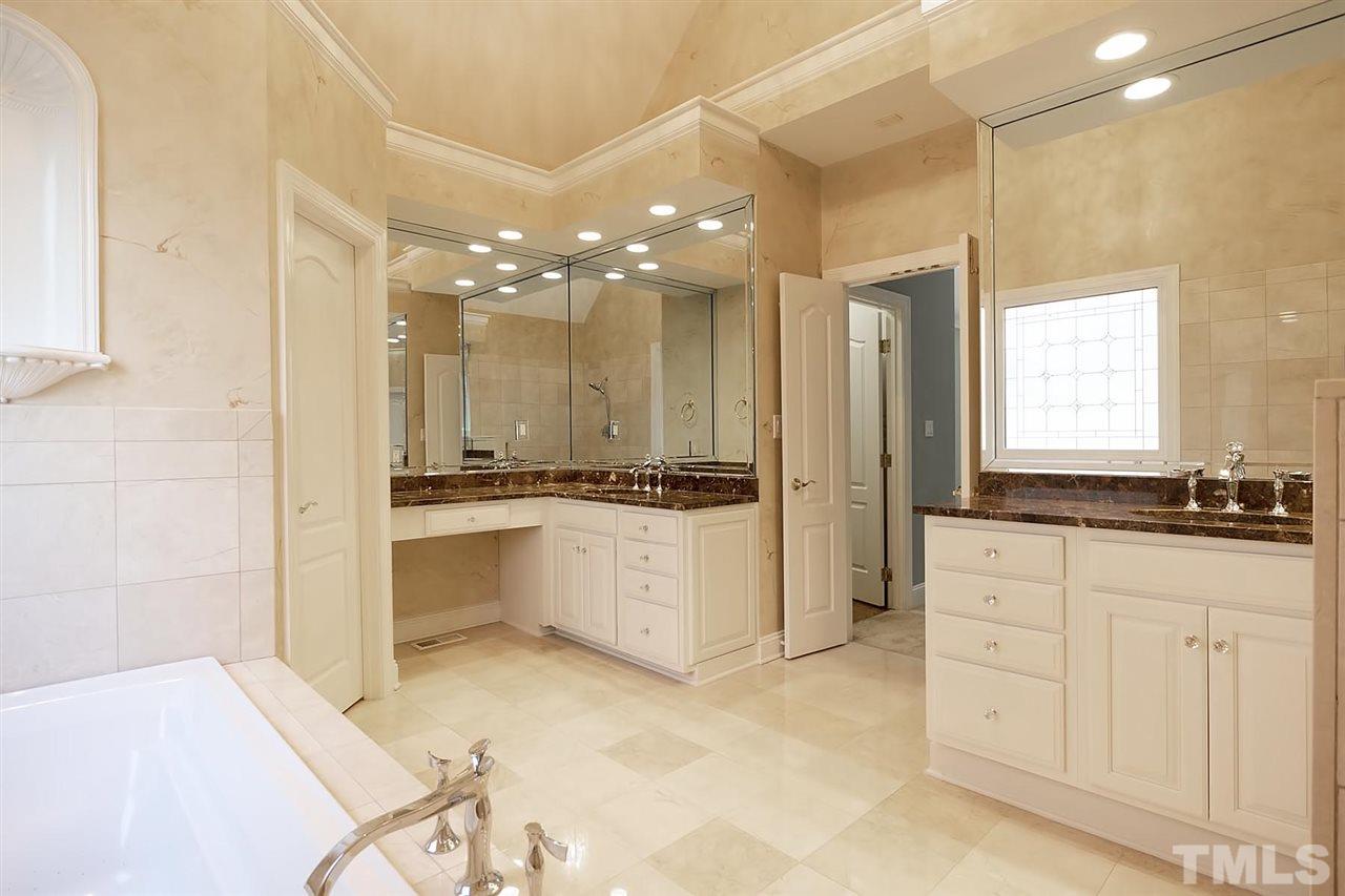 5220 Deergrass Court Raleigh, NC 27613 - Photo 17 of 25 a large bathroom with a large tub and sink
