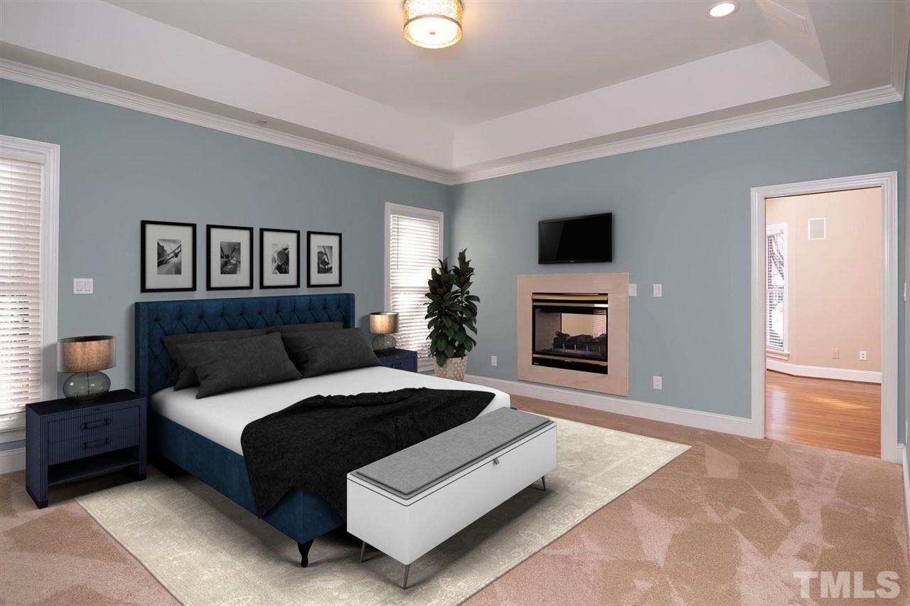 5220 Deergrass Court Raleigh, NC 27613 - Photo 19 of 25 a spacious bedroom with a large bed and a fireplace