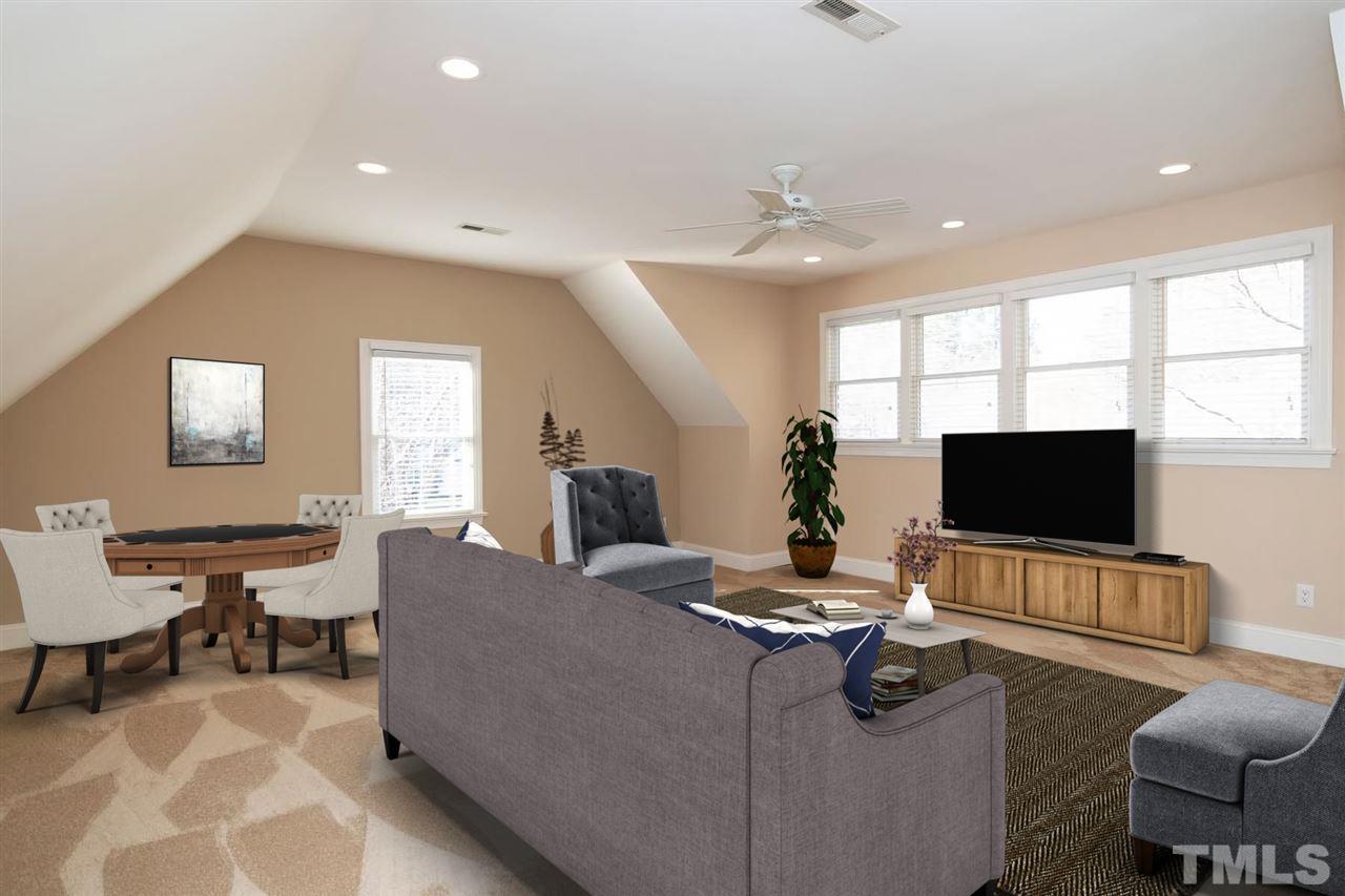 5220 Deergrass Court Raleigh, NC 27613 - Photo 20 of 25 a living room with furniture and a flat screen tv