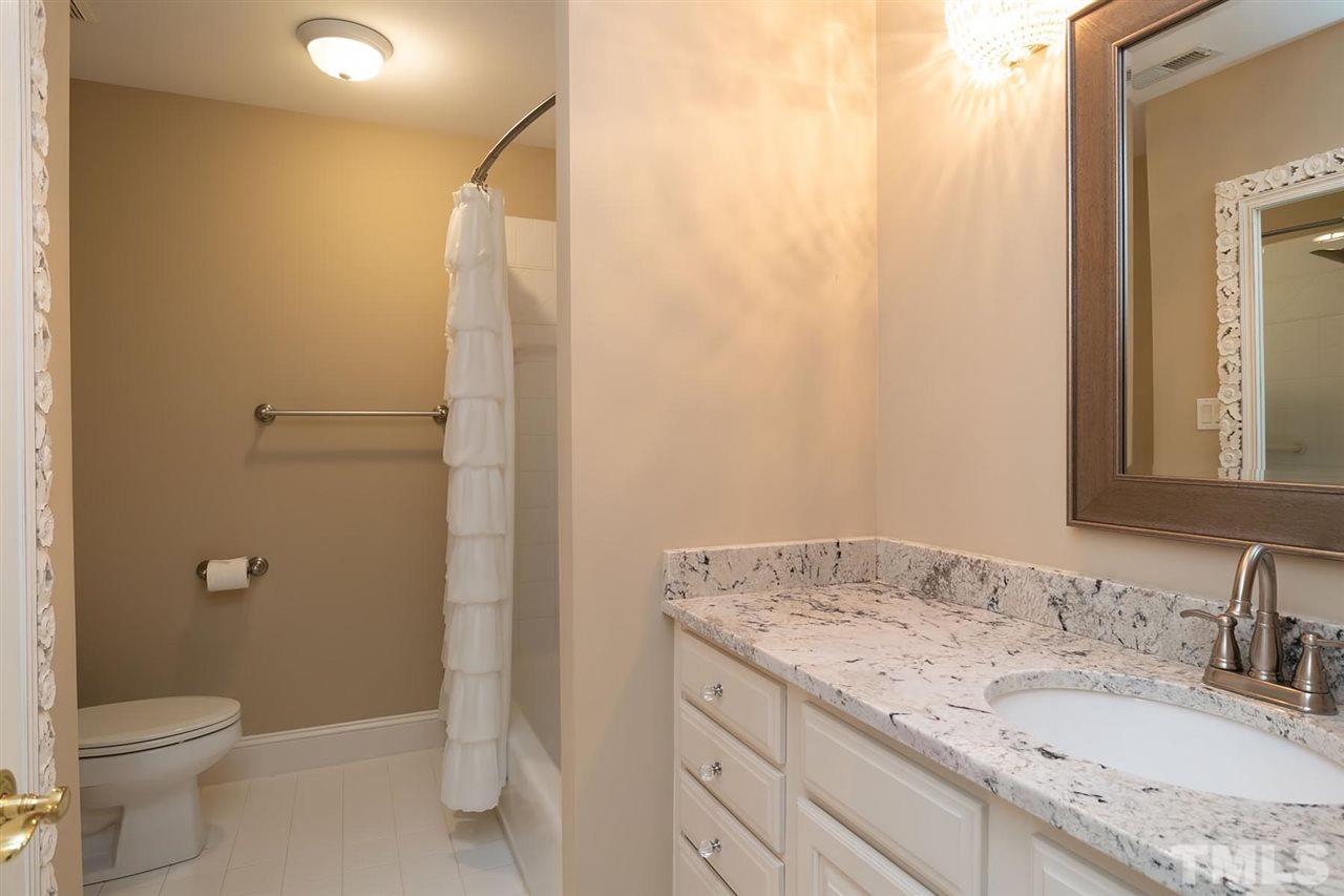 5220 Deergrass Court Raleigh, NC 27613 - Photo 22 of 25 a bathroom with a granite countertop sink toilet and shower