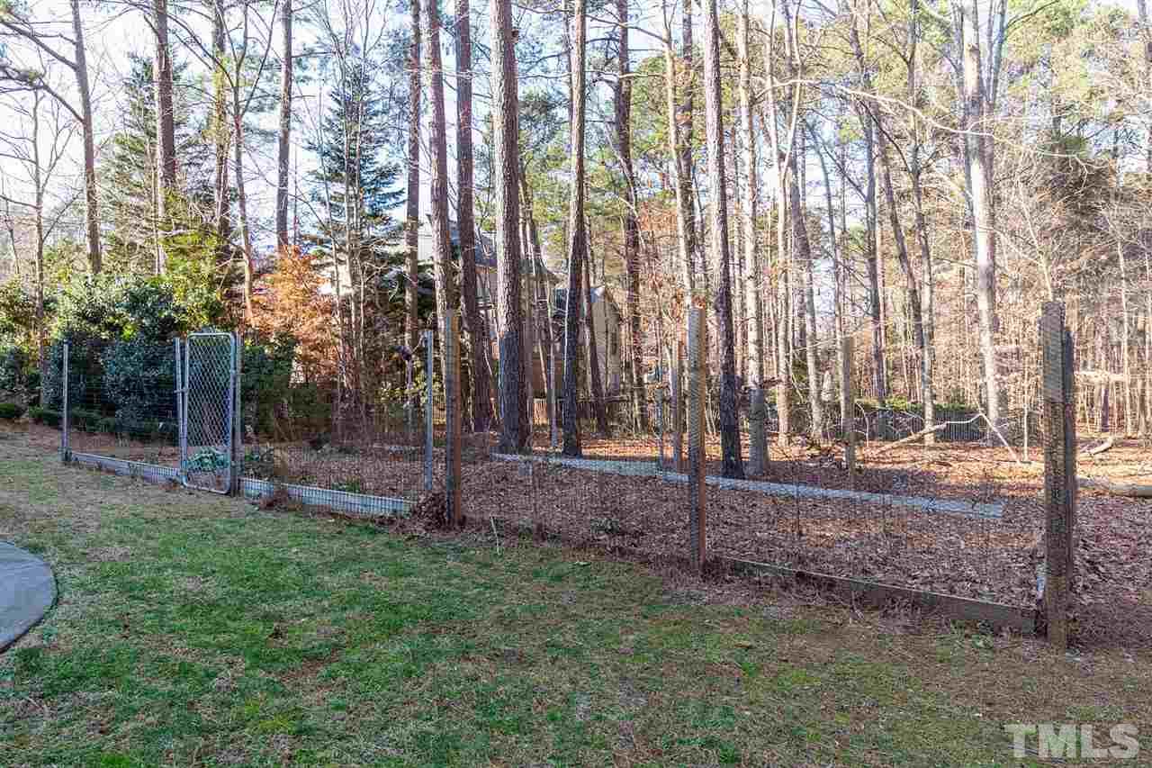 5220 Deergrass Court Raleigh, NC 27613 - Photo 25 of 25 a backyard of a house with lots of green space
