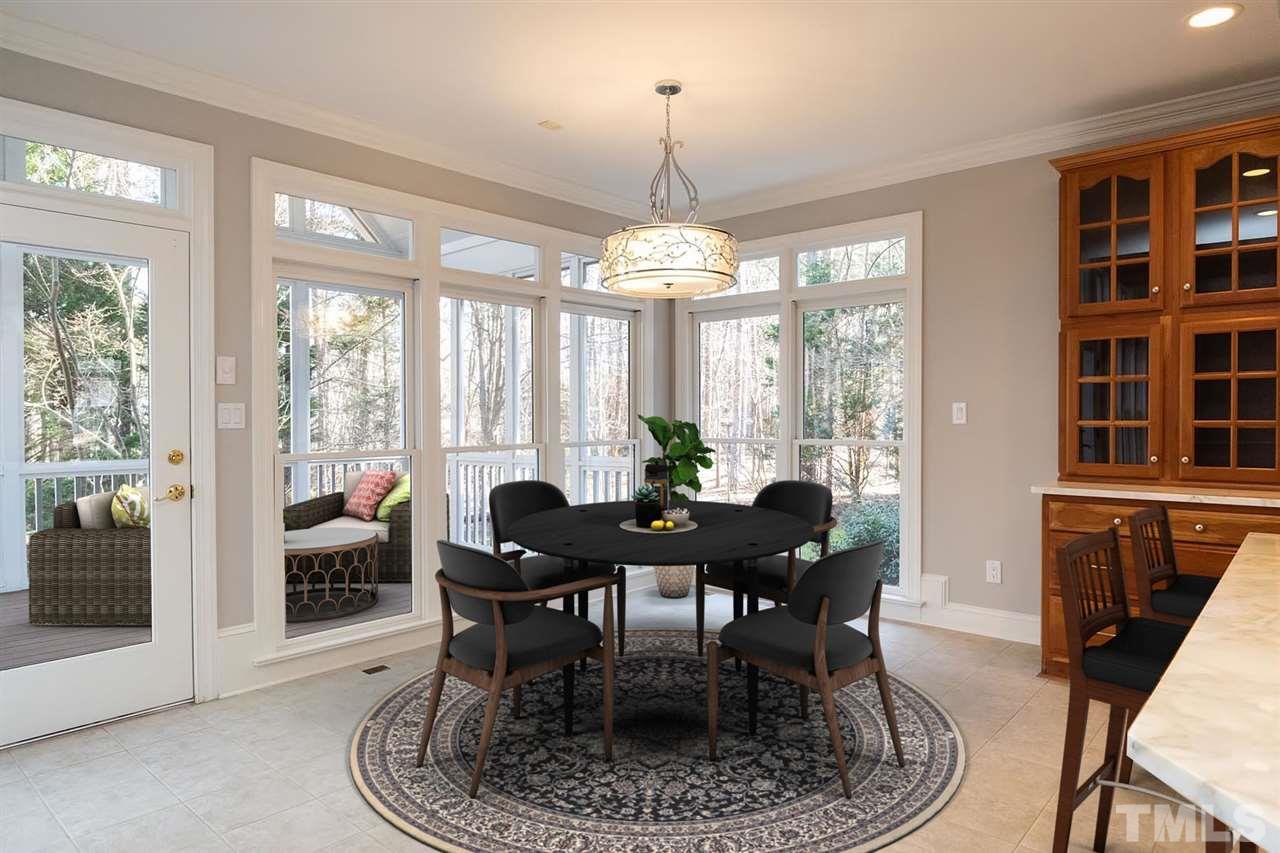 5220 Deergrass Court Raleigh, NC 27613 - Photo 10 of 25 a dining room with furniture a chandelier and wooden floor