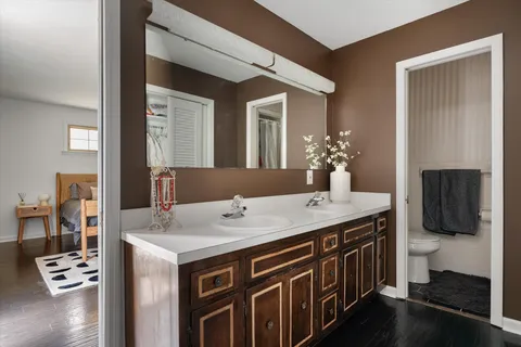 a white toilet sitting next to a bathroom sink
