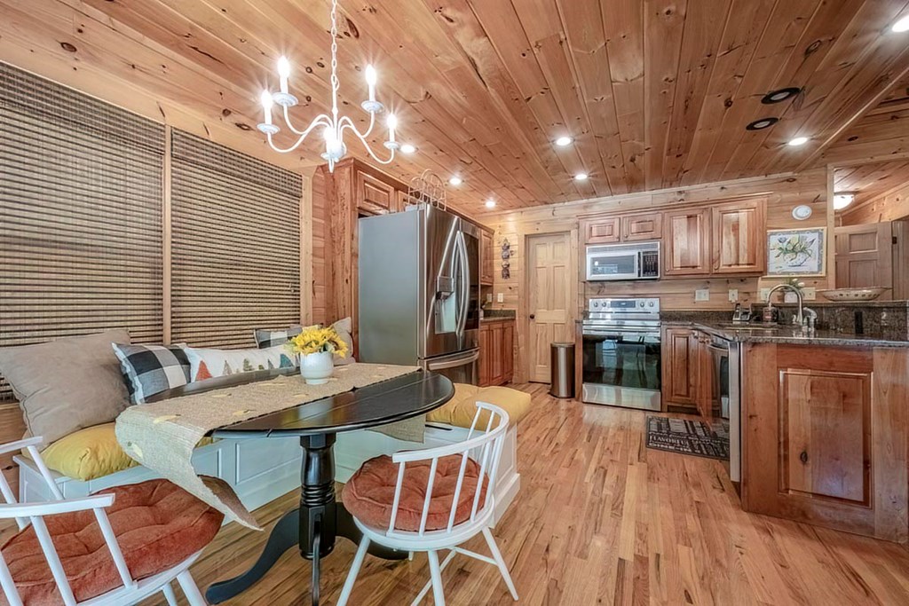 781 Mangum's Trail Blue Ridge, GA 30513 - Photo 13 of 65 a view of a dining room with furniture a kitchen and chandelier