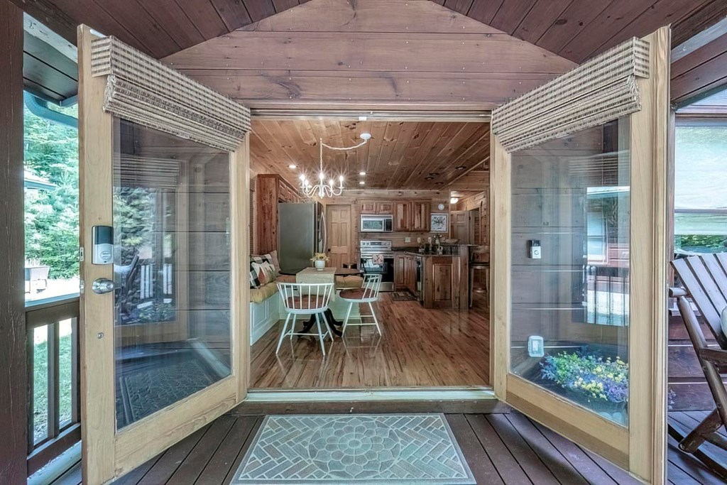 781 Mangum's Trail Blue Ridge, GA 30513 - Photo 14 of 65 a view of a dining room with furniture wooden floor and a potted plant