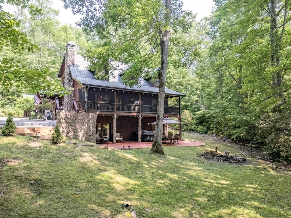 781 Mangum's Trail Blue Ridge, GA 30513 - Photo 24 of 65 a view of a house with backyard and sitting area