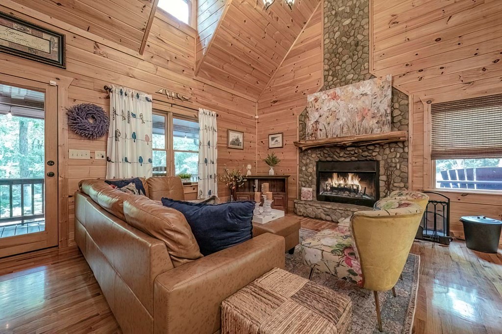 781 Mangum's Trail Blue Ridge, GA 30513 - Photo 3 of 65 a living room with furniture a large window and a fireplace