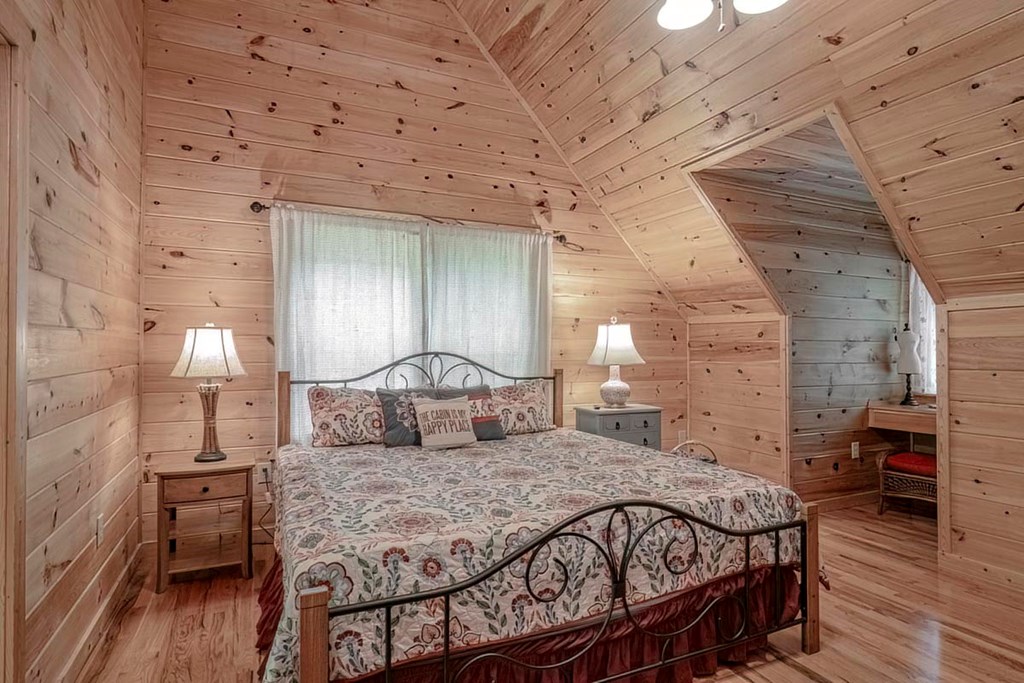 781 Mangum's Trail Blue Ridge, GA 30513 - Photo 33 of 65 a bedroom with a bed and wooden floor