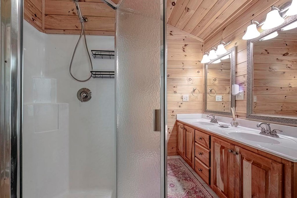 781 Mangum's Trail Blue Ridge, GA 30513 - Photo 36 of 65 a bathroom with a double vanity sink and mirror