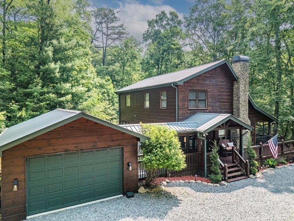 781 Mangum's Trail Blue Ridge, GA 30513 - Photo 4 of 65 a front view of a house with a garden