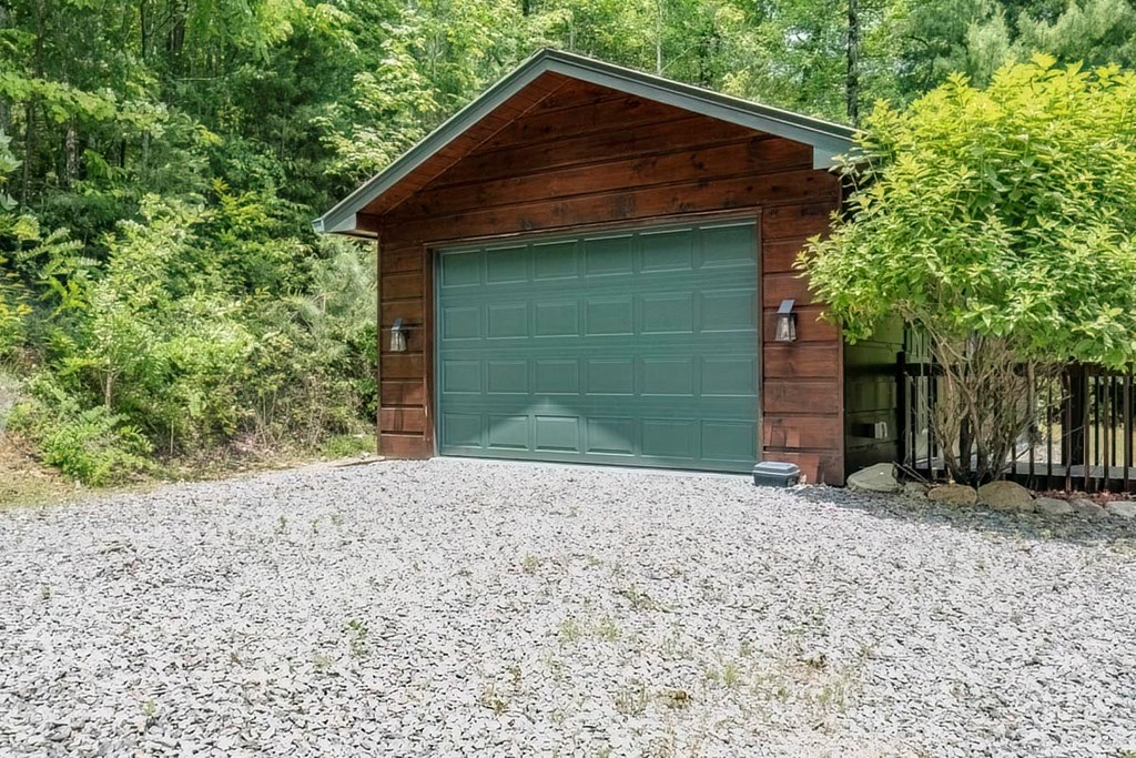781 Mangum's Trail Blue Ridge, GA 30513 - Photo 41 of 65 a front view of a house with a yard and garage