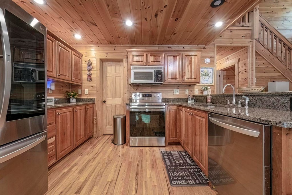 781 Mangum's Trail Blue Ridge, GA 30513 - Photo 5 of 65 a kitchen with stainless steel appliances granite countertop a stove a sink and a refrigerator