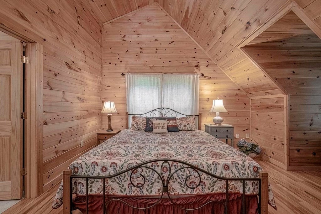 781 Mangum's Trail Blue Ridge, GA 30513 - Photo 7 of 65 a large bedroom with a bed and wooden floor