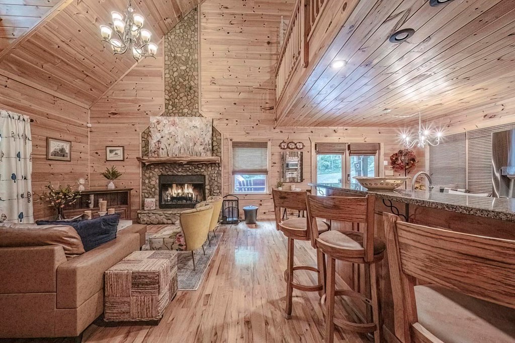 781 Mangum's Trail Blue Ridge, GA 30513 - Photo 8 of 65 a living room with furniture a fireplace and a chandelier