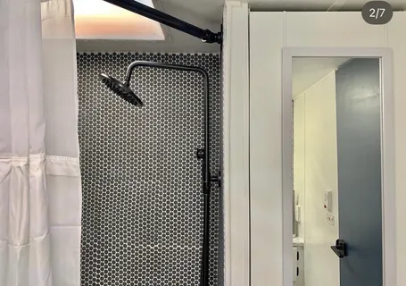 a bathroom with a glass shower door