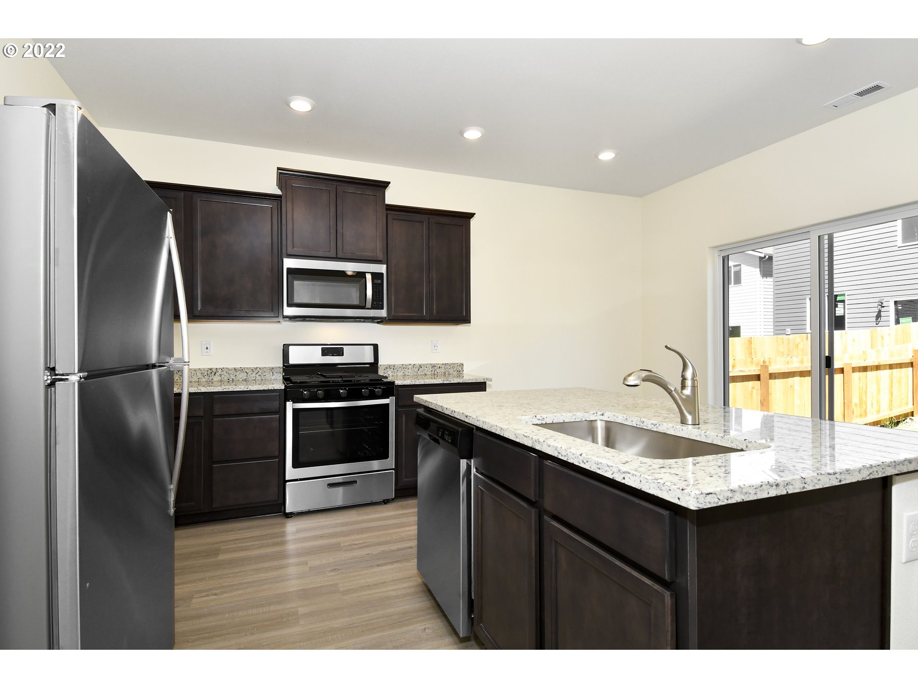 4133 Southwest Hartley Avenue Gresham, OR 97080 - Photo 5 of 10 a kitchen with kitchen island a sink stainless steel appliances and counter space