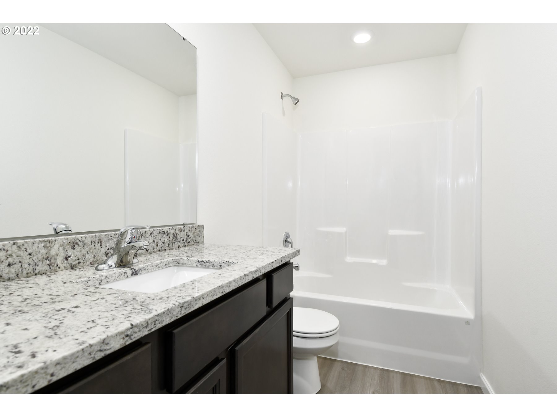 4133 Southwest Hartley Avenue Gresham, OR 97080 - Photo 10 of 10 a bathroom with a granite countertop sink a toilet and bathtub
